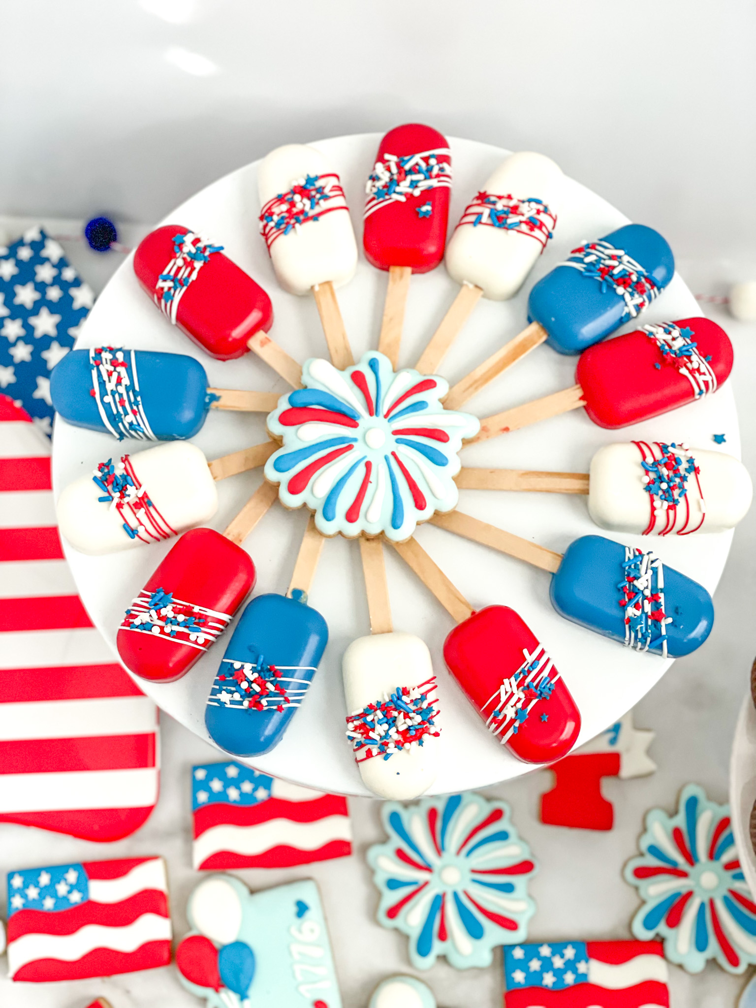 4th of July cakesicles in red, white and blue with coordinating sprinkles