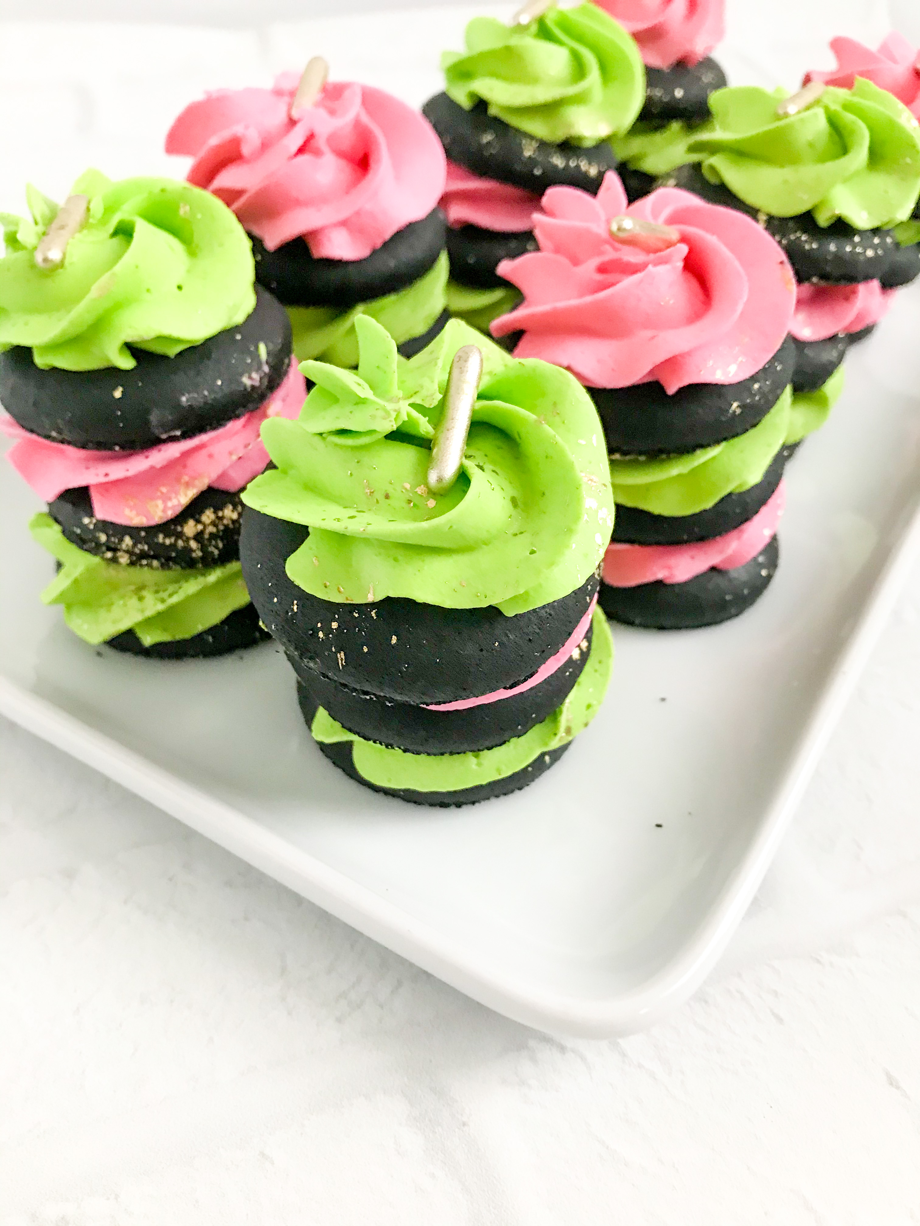 pink and green buttercream and black macaron stack