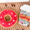 red donut with sprinkles with coffee cup red donut with sprinkles with coffee cup