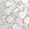 white and pale pink cross. christening gown, and cross with floral accents white and pale pink cross. christening gown, and cross with floral accents