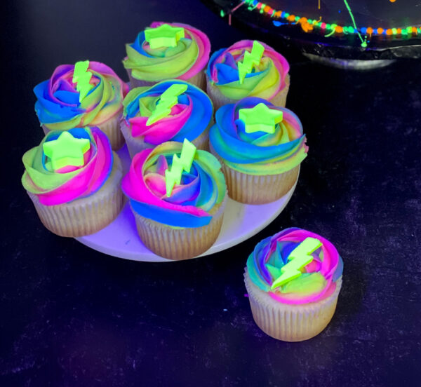vanilla cupcakes with chocolate toppers Glow in the dark birthday cupcakes with neon buttercream and star and lightning toppers
