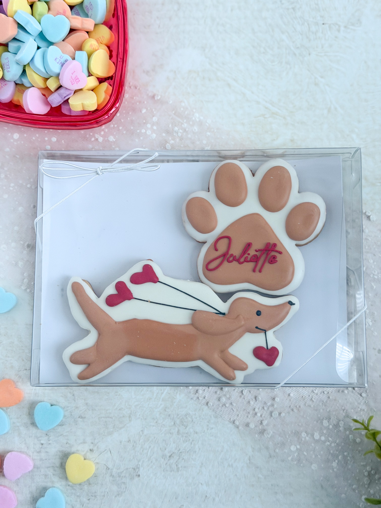Weiner dog holding heart balloons and personalized paw print