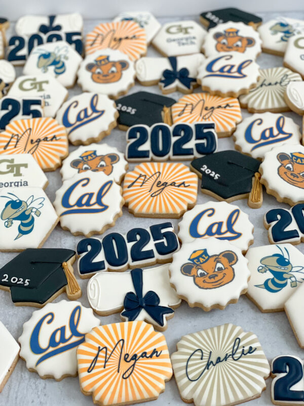 Custom graduation sugar cookies decorated with 2025 numbers, graduation caps, diplomas, and personalized name designs in school color palettes.