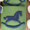 navy blue rocking horse on green background