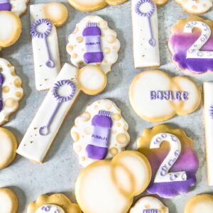 Bubbles, bubble wand, #2 and bottle of bubbles in shades of purple, white, and gold