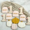 Personalized lil pumpkin first birthday cookies Custom fall first birthday sugar cookies decorated with pumpkins, autumn leaves, gold details, and personalized birthday cookies in soft blush, white, and warm fall colors.